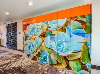 A mural of succulents is on the wall of a hallway.